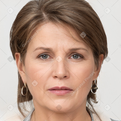 Joyful white adult female with medium  brown hair and grey eyes