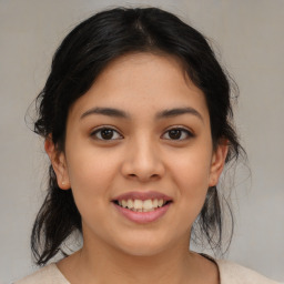 Joyful latino young-adult female with medium  brown hair and brown eyes