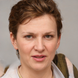 Joyful white adult female with medium  brown hair and blue eyes