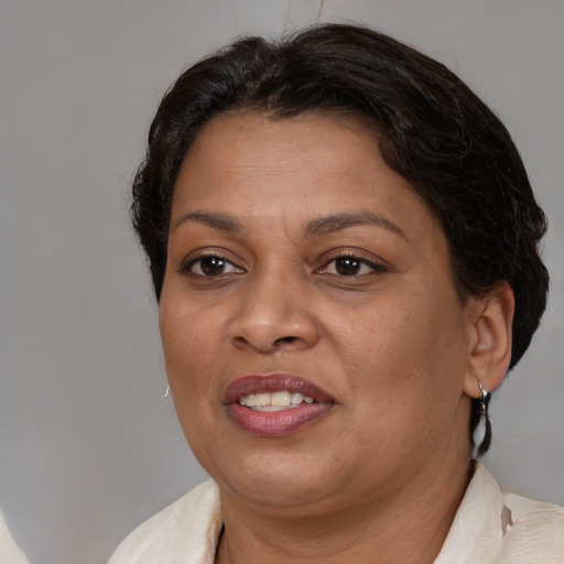 Joyful black adult female with medium  brown hair and brown eyes