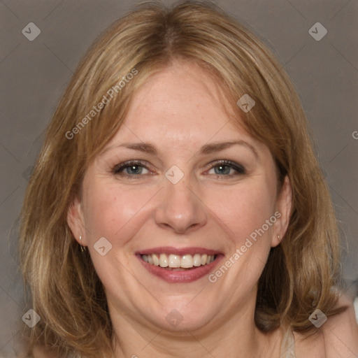 Joyful white adult female with medium  brown hair and grey eyes