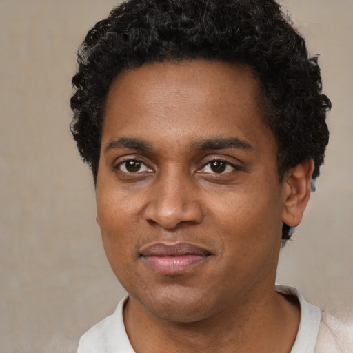 Joyful black young-adult male with short  black hair and brown eyes
