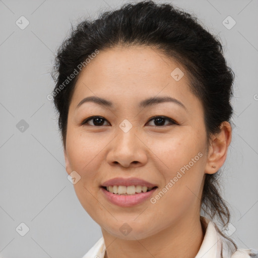 Joyful asian young-adult female with short  brown hair and brown eyes