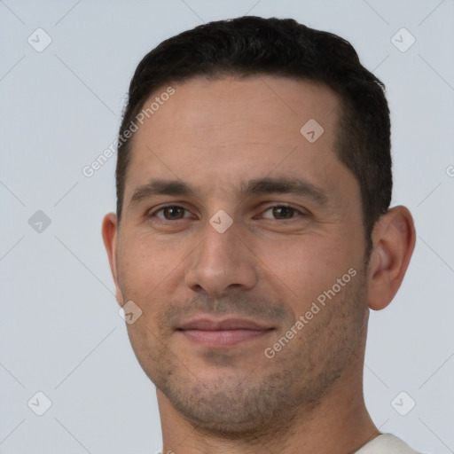 Joyful white young-adult male with short  brown hair and brown eyes