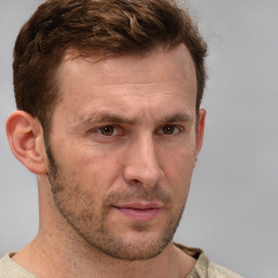 Joyful white adult male with short  brown hair and grey eyes