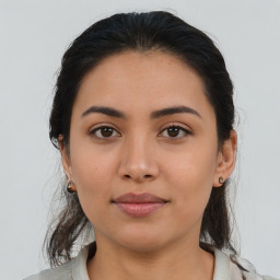 Joyful latino young-adult female with medium  brown hair and brown eyes