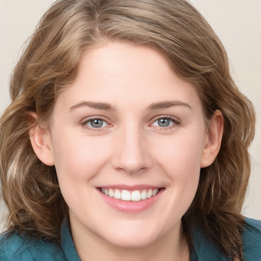 Joyful white young-adult female with medium  brown hair and blue eyes