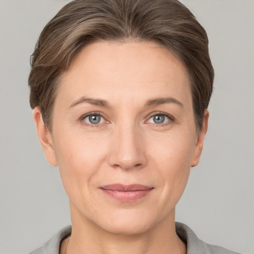 Joyful white adult female with short  brown hair and grey eyes