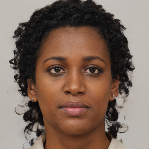 Neutral black young-adult female with medium  brown hair and brown eyes