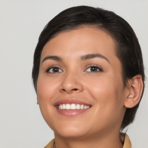 Joyful white young-adult female with short  brown hair and brown eyes