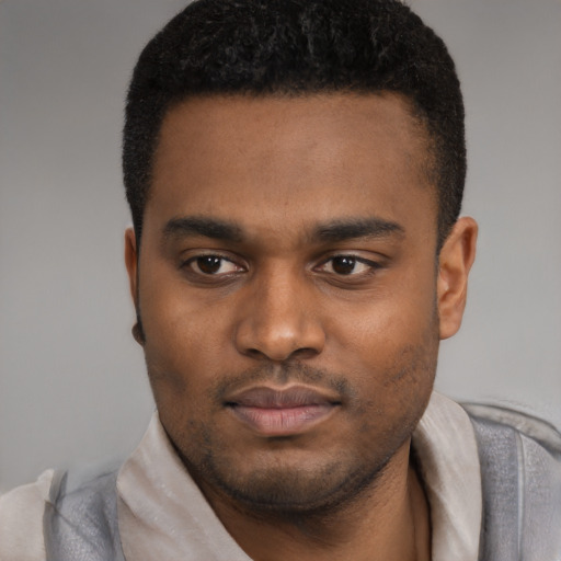 Joyful latino young-adult male with short  brown hair and brown eyes