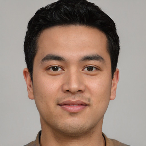 Joyful asian young-adult male with short  black hair and brown eyes