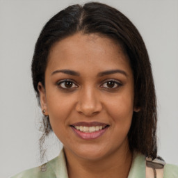 Joyful black young-adult female with medium  brown hair and brown eyes