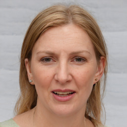 Joyful white adult female with medium  brown hair and grey eyes