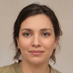 Joyful white young-adult female with medium  brown hair and brown eyes