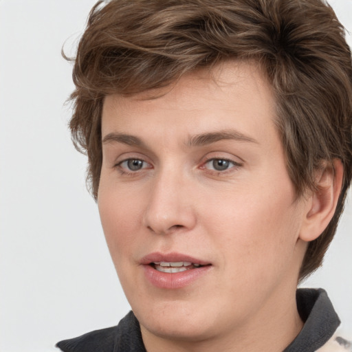 Joyful white young-adult male with medium  brown hair and grey eyes