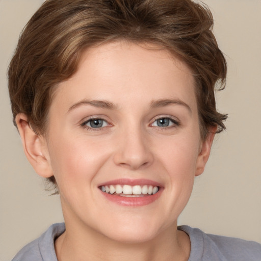 Joyful white young-adult female with short  brown hair and grey eyes