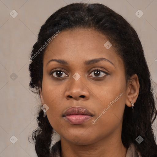 Joyful black young-adult female with long  black hair and brown eyes