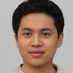 Joyful asian young-adult male with short  brown hair and brown eyes