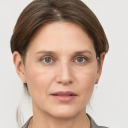 Joyful white adult female with short  brown hair and grey eyes