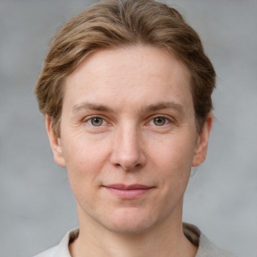 Joyful white adult female with short  brown hair and grey eyes