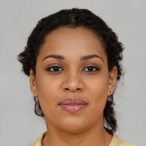 Joyful black young-adult female with short  brown hair and brown eyes