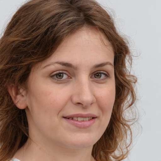 Joyful white adult female with medium  brown hair and blue eyes