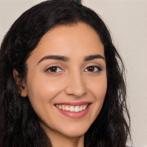 Joyful latino young-adult female with long  brown hair and brown eyes