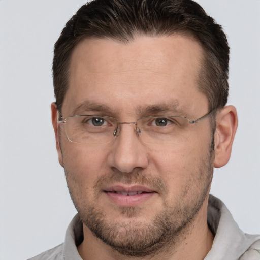 Joyful white adult male with short  brown hair and brown eyes