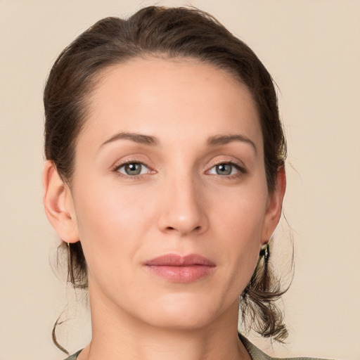 Joyful white young-adult female with medium  brown hair and grey eyes