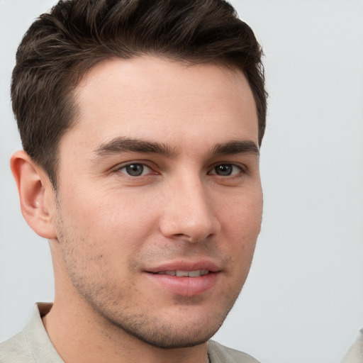 Joyful white young-adult male with short  brown hair and grey eyes