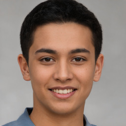 Joyful latino young-adult male with short  brown hair and brown eyes