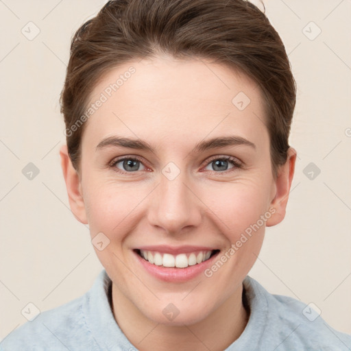 Joyful white young-adult female with short  brown hair and grey eyes