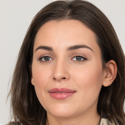 Joyful white young-adult female with medium  brown hair and brown eyes