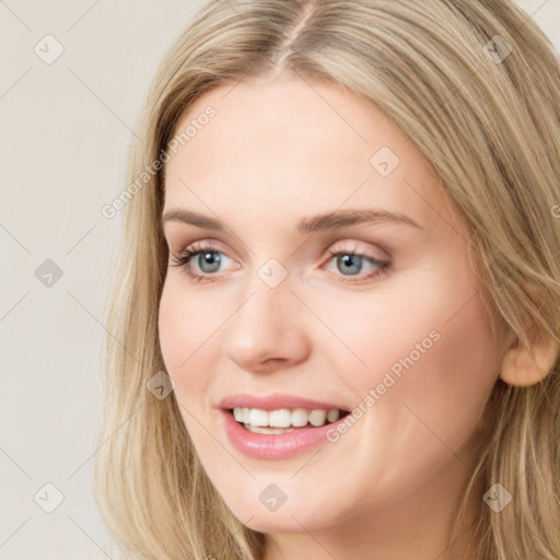 Joyful white young-adult female with long  brown hair and blue eyes