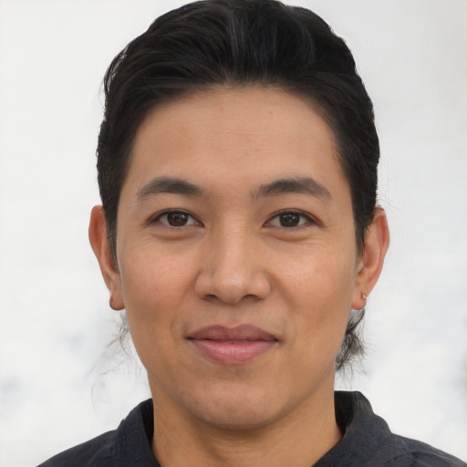 Joyful asian young-adult male with short  black hair and brown eyes