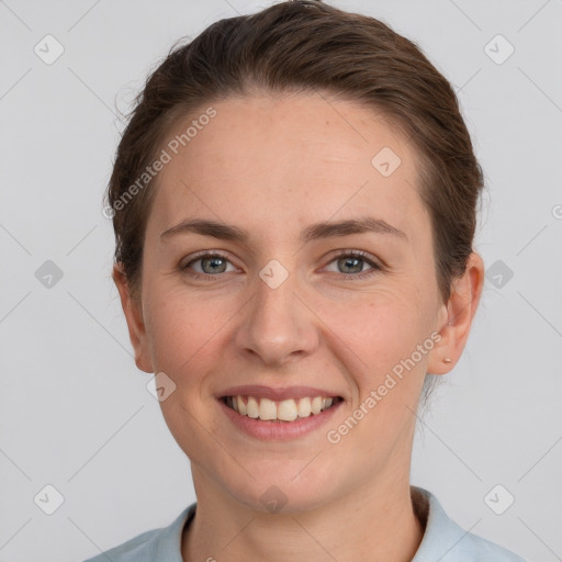 Joyful white young-adult female with short  brown hair and grey eyes