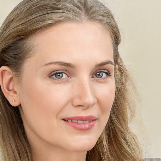 Joyful white young-adult female with long  brown hair and blue eyes