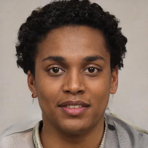 Joyful black young-adult male with short  black hair and brown eyes