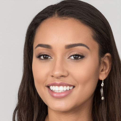 Joyful white young-adult female with long  brown hair and brown eyes