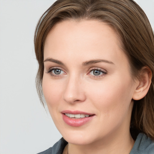 Joyful white young-adult female with long  brown hair and grey eyes