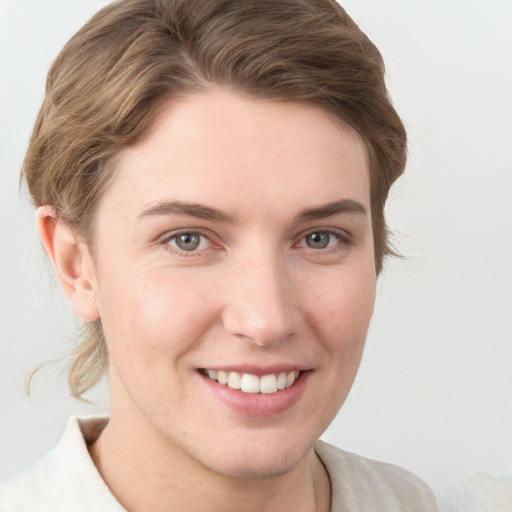 Joyful white young-adult female with short  brown hair and grey eyes