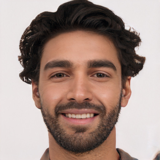 Joyful white young-adult male with short  black hair and brown eyes