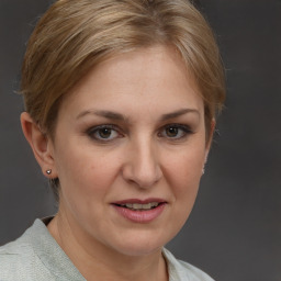 Joyful white adult female with short  brown hair and grey eyes