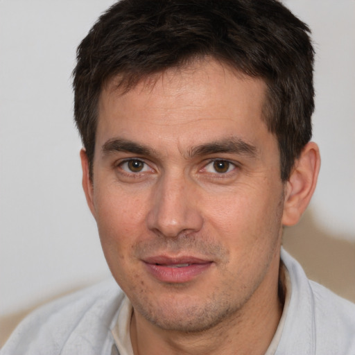 Joyful white adult male with short  brown hair and brown eyes