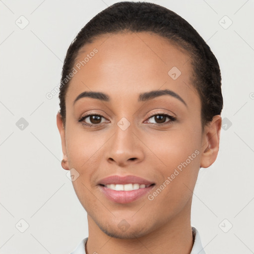 Joyful latino young-adult female with short  black hair and brown eyes