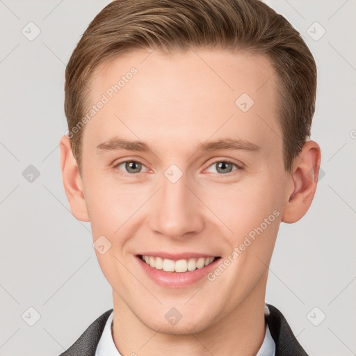 Joyful white young-adult male with short  brown hair and grey eyes