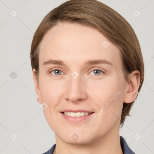 Joyful white young-adult female with short  brown hair and grey eyes