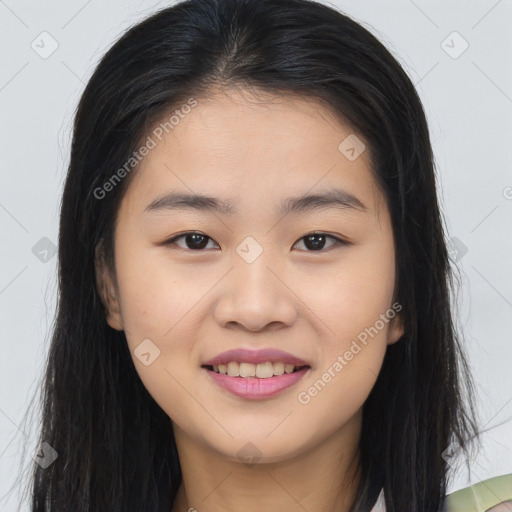 Joyful asian young-adult female with long  brown hair and brown eyes