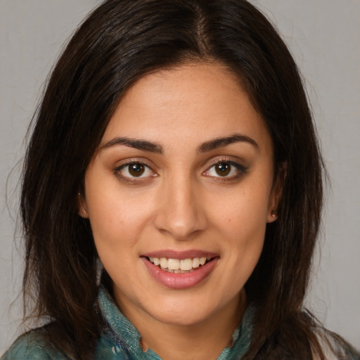 Joyful white young-adult female with long  brown hair and brown eyes